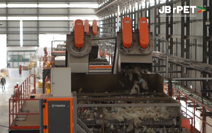 Industrial plastic sorting and recycling machinery processing PET waste at JB rPET facility