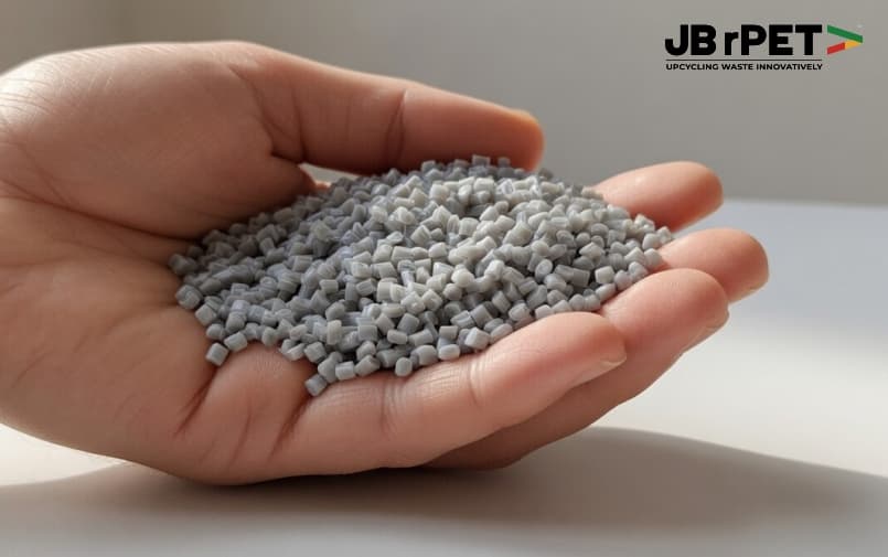 Recycled PET plastic granules held in hand showing high-quality rPET material production