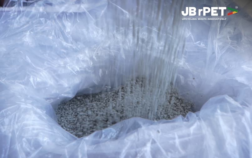 Recycled PET resin granules being collected in an industrial storage bag