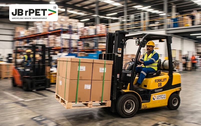 Forklift transporting packages secured with green PET straps in a warehouse